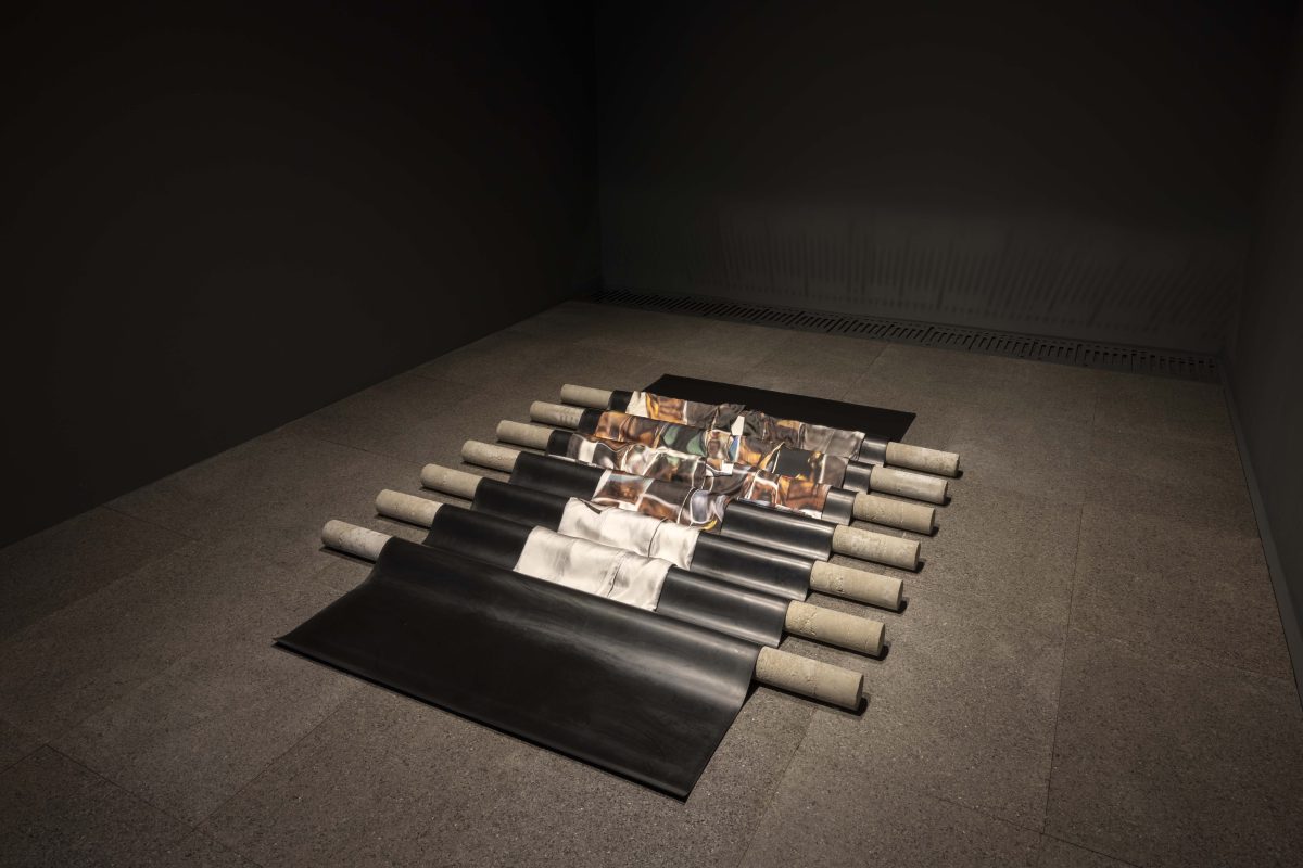 <I>Sleeping Kimono</i>, 2022
</br>digitally printed silk, cotton, silk, synthetic, rubber, concrete, 12 basalt plates</br>
13 x 300 x 360 cm / 5.1 x 118.1 x 141.7 in