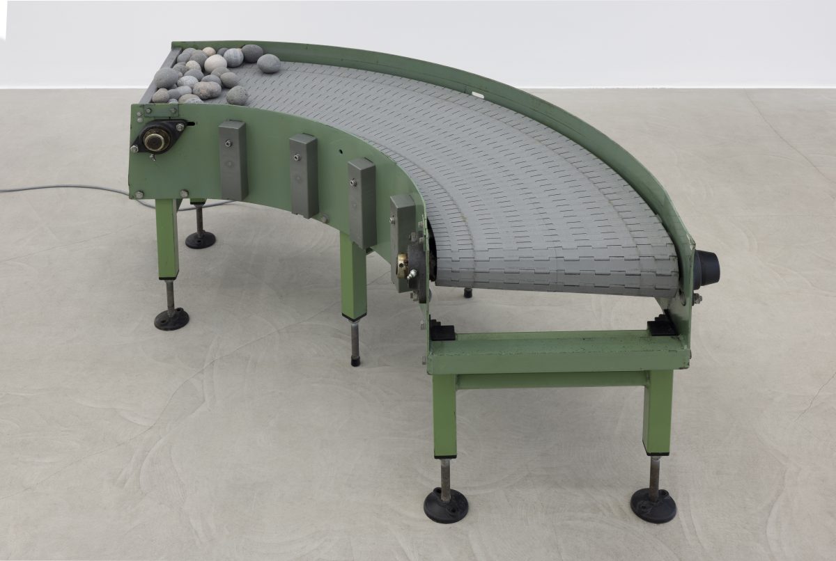 <i>Murmur</i> 2025 </br>
modified conveyor belt, rocks </br> 125 x 115 x 61 cm / 49.3 x 45.2 x 24 in