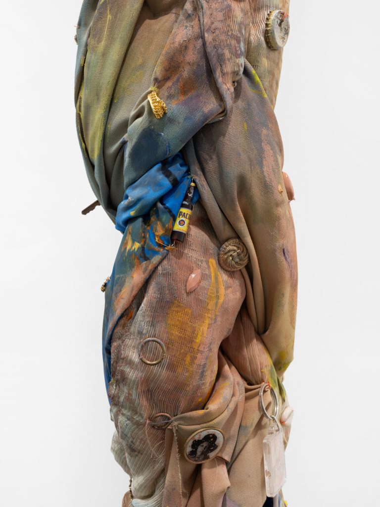 <i>Charm for humanity,</i> 2022</br>
fabric, acrylic and spray paint, found lucky charms, gold chain, </br> feather, gems, key ring, brass chain, vibrational energy of purification and trust</br> 177,8 x 15 cm / 70 x 5.9 in