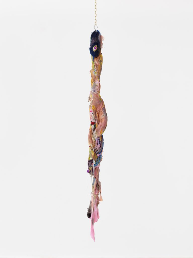 <i>Charm for humanity,</i> 2022</br>
fabric, acrylic and spray paint, found lucky charms, gold chain, </br> feather, gems, key ring, brass chain, vibrational energy of purification and trust</br> 177,8 x 15 cm / 70 x 5.9 in