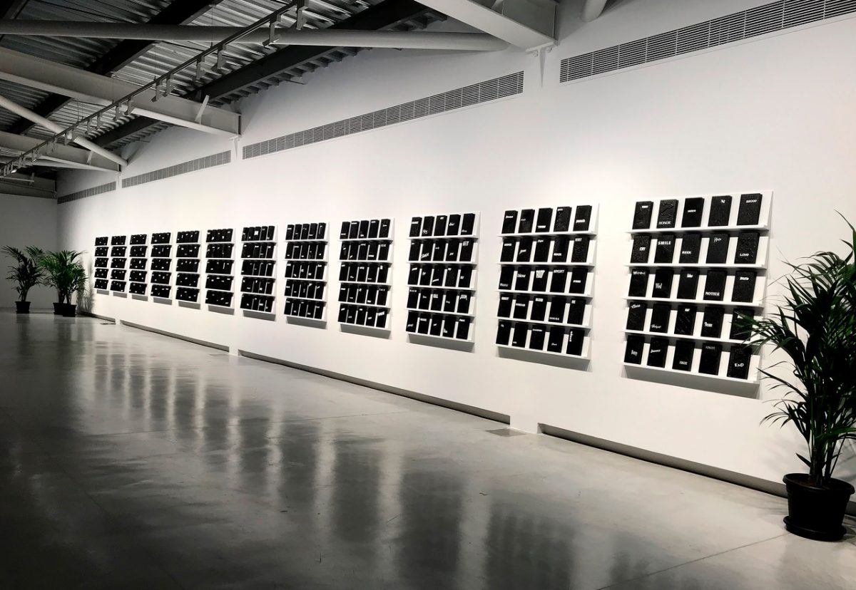 <i>digest</i>, 2019
</br>
 Installation view, Sharjah Biennial 14, Sharjah
</br>
multichannel video installation, 300 units: 20,3 x 12 x 2,7 cm / 8 x 4.7 x 1.1 in
</br>
each 70 shelves, videotape, polypropylene boxes, paper and acrylic paint 
</br>
commissioned by Sharjah Art Foundation>