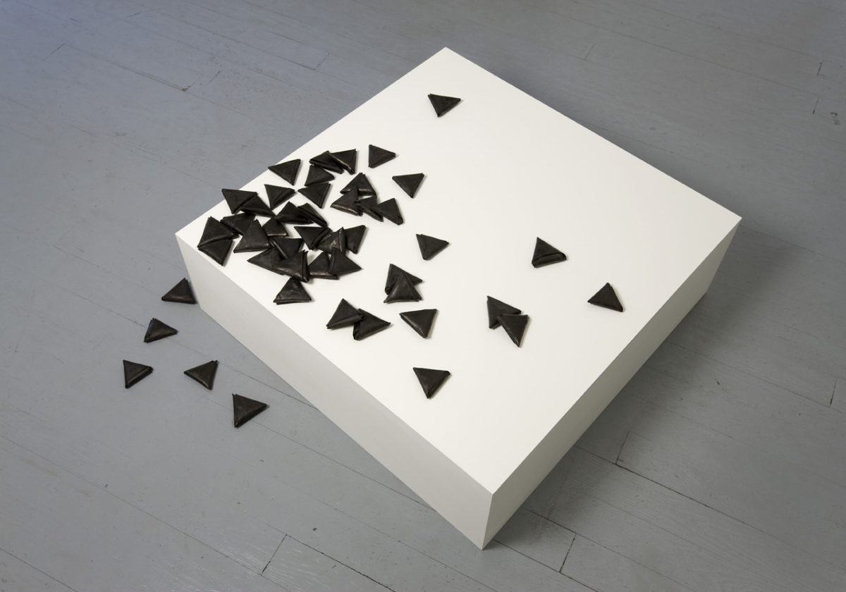 <i>les petites lettres</i>, 2009</br>48 pieces of paper dyed with black chinese ink, mdf pedestal</br>86 x 86 x 27 cm / 33.9 x 33.9 x 10.6 in