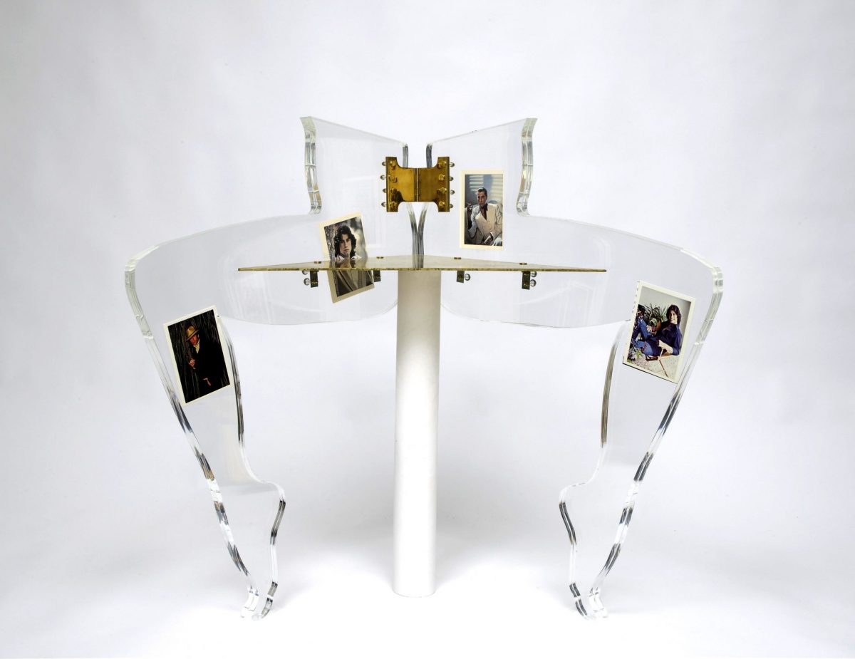 <i>leg chair (john travolta)</i>, 2010 
</br>
postcards, perspex, plaster, brass, 84 x 85 x 43 cm / 33.1 x 33.5 x 16.9 in
>