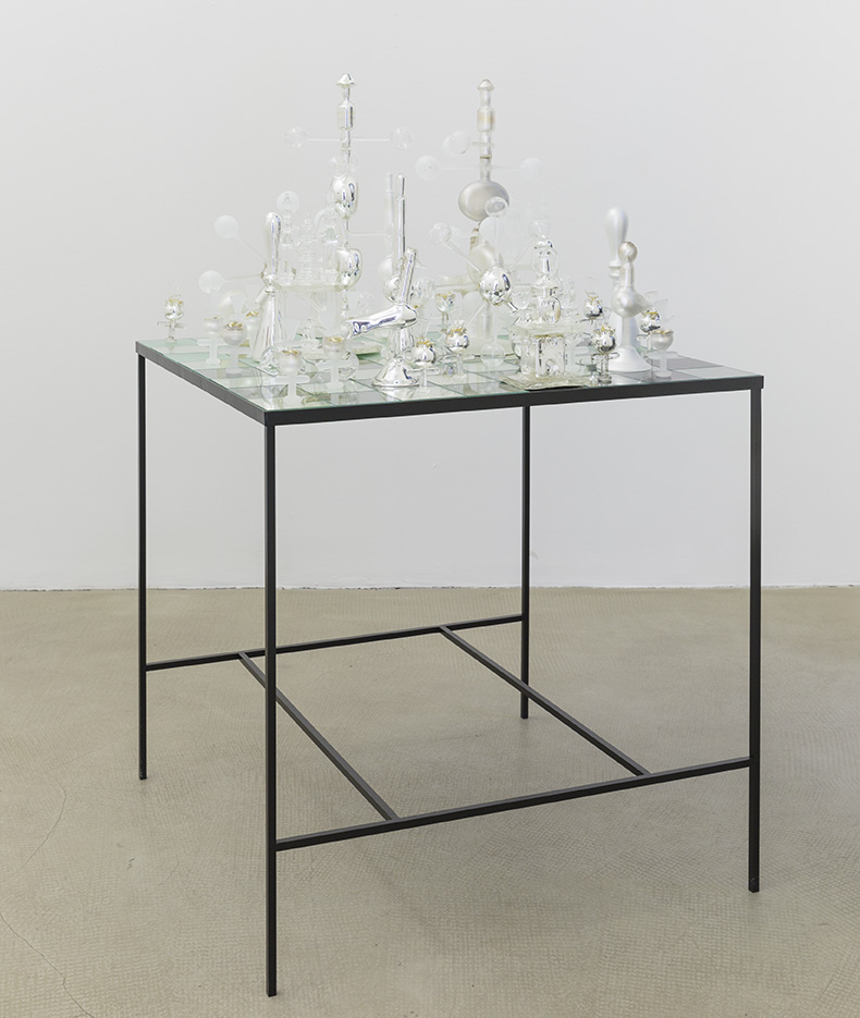 <i>yield event</i>, 2014 
</br>
steel, 35 glass chess pieces, table: 81 x 81 cm / 31.9 x 31.9 in>