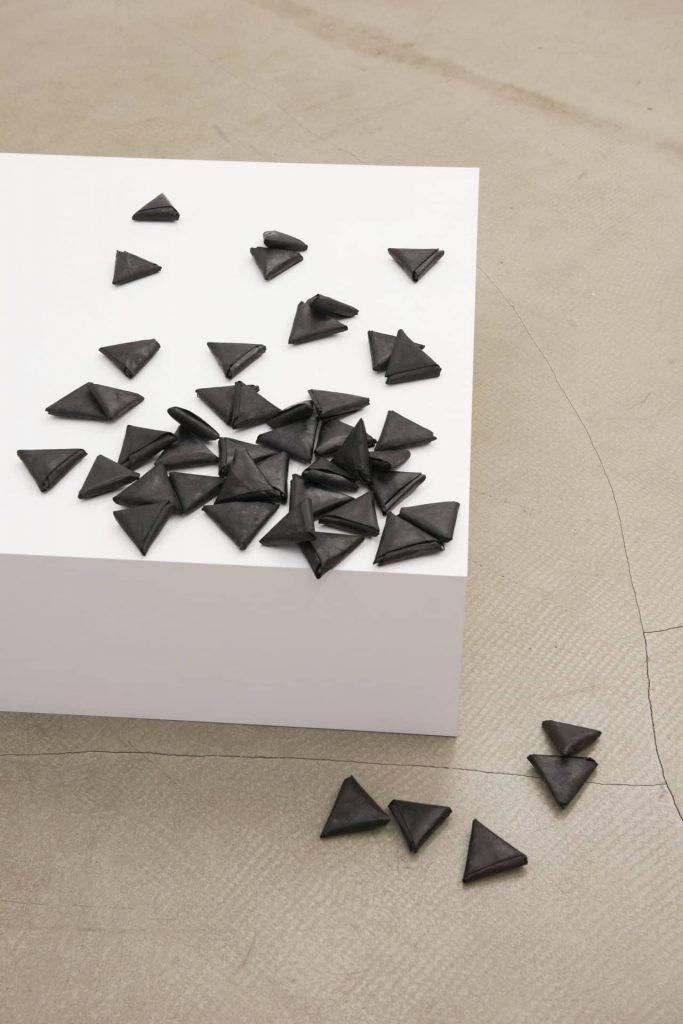 latifa echakhch, les petites lettres, 2009
48 pieces of paper dyed with black chinese ink, mdf and paper pedestal, 86 × 86 × 27 cm