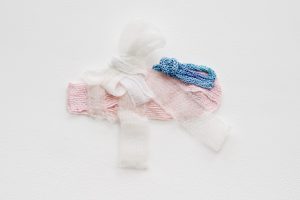 Hana Miletić, <i>Materials</i>, 1993</br>hand-woven and hand-knit textile (pale blue
repurposed mercerized cotton, recycled nylon,
repurposed plastic, rose pink organic raw wool,
variegated blue organic silk and white gauze yarn)</br>
12 x 21 x 3 cm / 7.5 x 8.3 x 1.3 in
