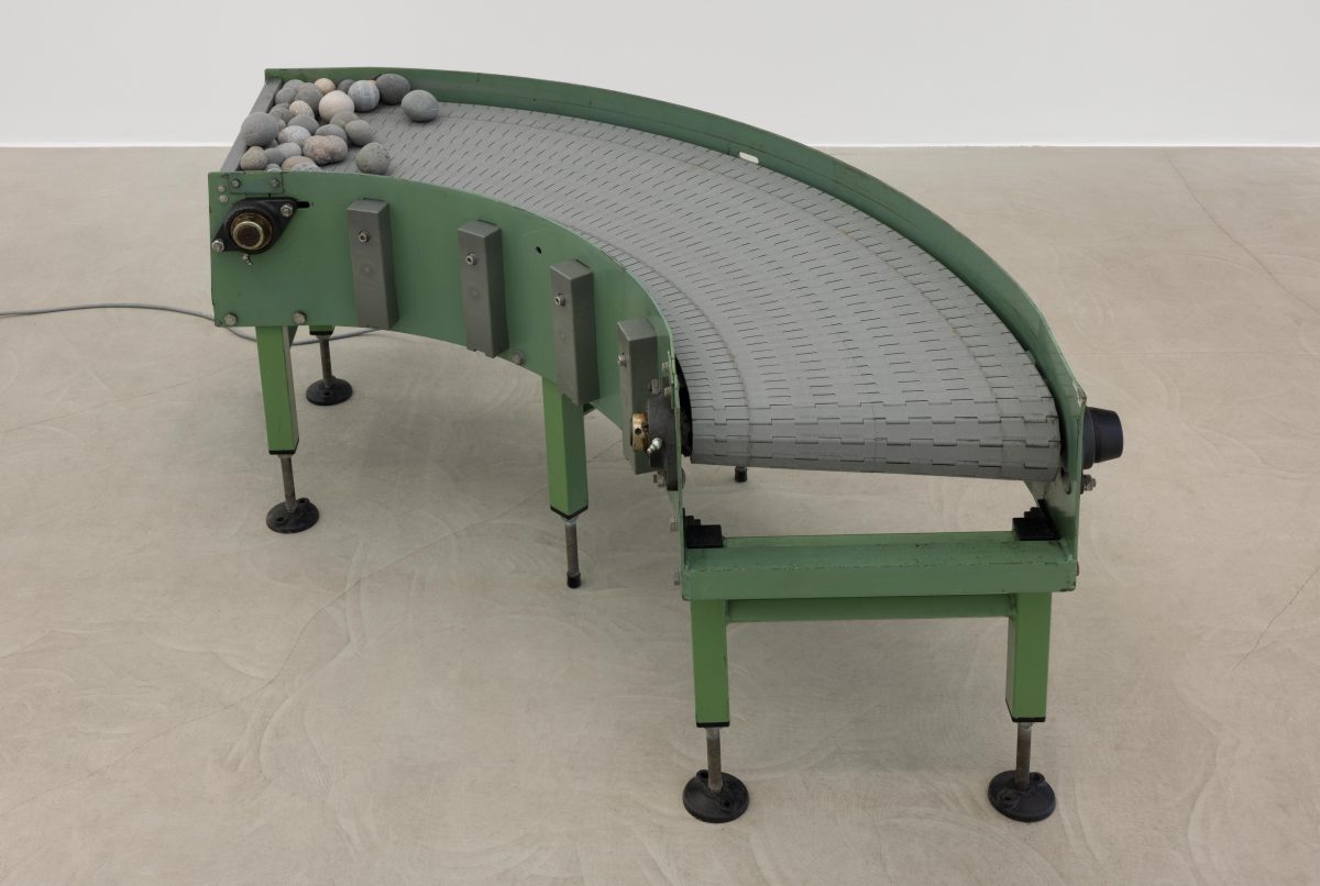 <i>Murmur</i> 2025 </br>
modified conveyor belt, rocks </br> 125 x 115 x 61 cm / 49.3 x 45.2 x 24 in