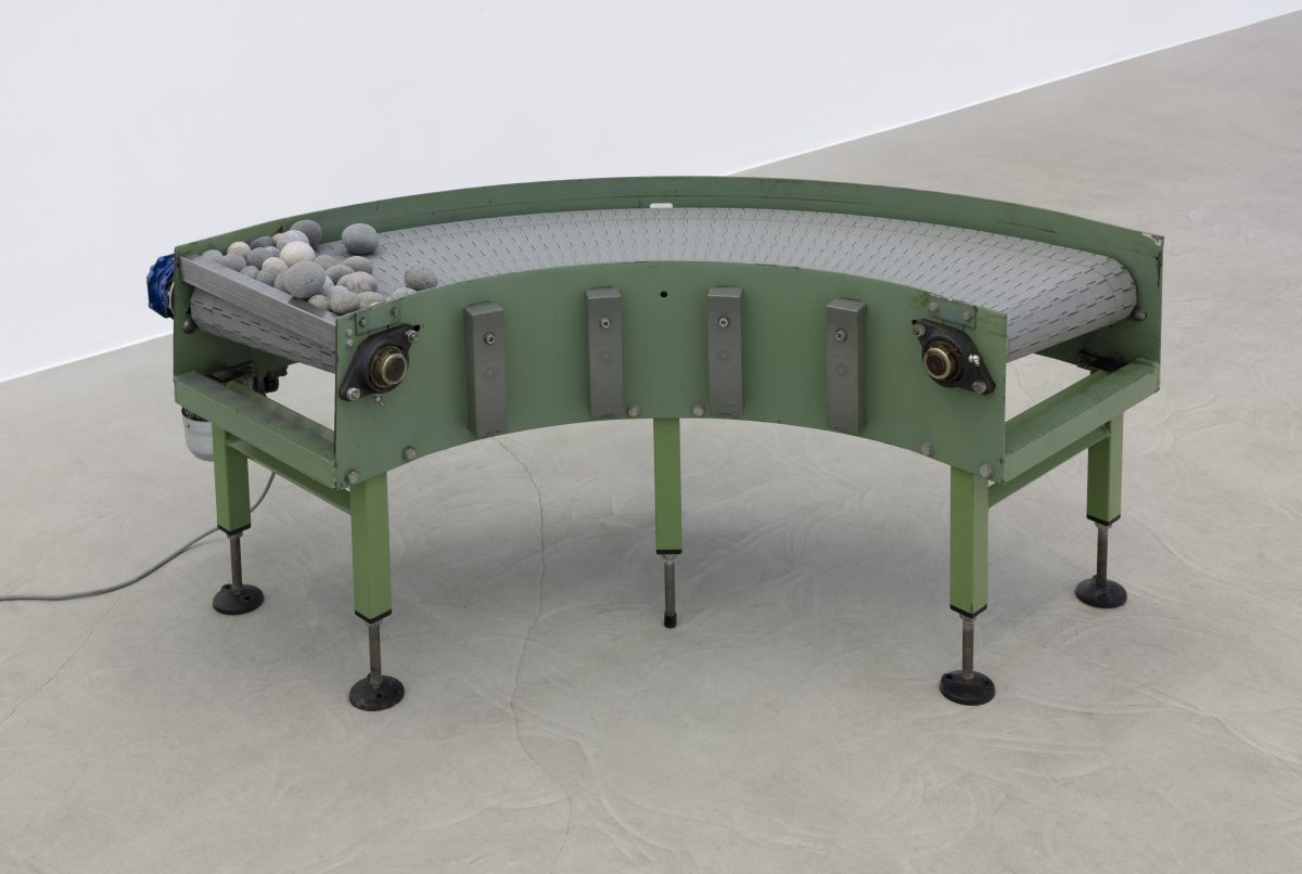 <i>Murmur</i> 2025</br>
modified conveyor belt, rocks </br> 125 x 115 x 61 cm / 49.3 x 45.2 x 24 in