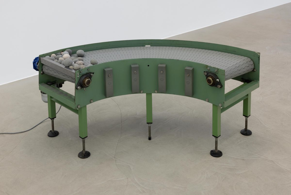 <i>Murmur</i> 2025</br>
modified conveyor belt, rocks </br> 125 x 115 x 61 cm / 49.3 x 45.2 x 24 in