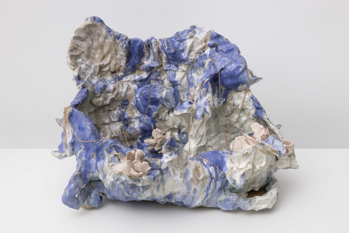 <i>Wishes vase</i>, 2025 </br>
 glazed ceramic, ceramic roses, plated gold chain</br>protocol: put your hands in front of your face. whisper a wish into your hands. collect the wish in your hands. </br>direct the wish into the vase. there are no restrictions on the amount of wishes.
</br>31 x 50 x 35 cm / 12.2 x 19.8 x 13.8 in